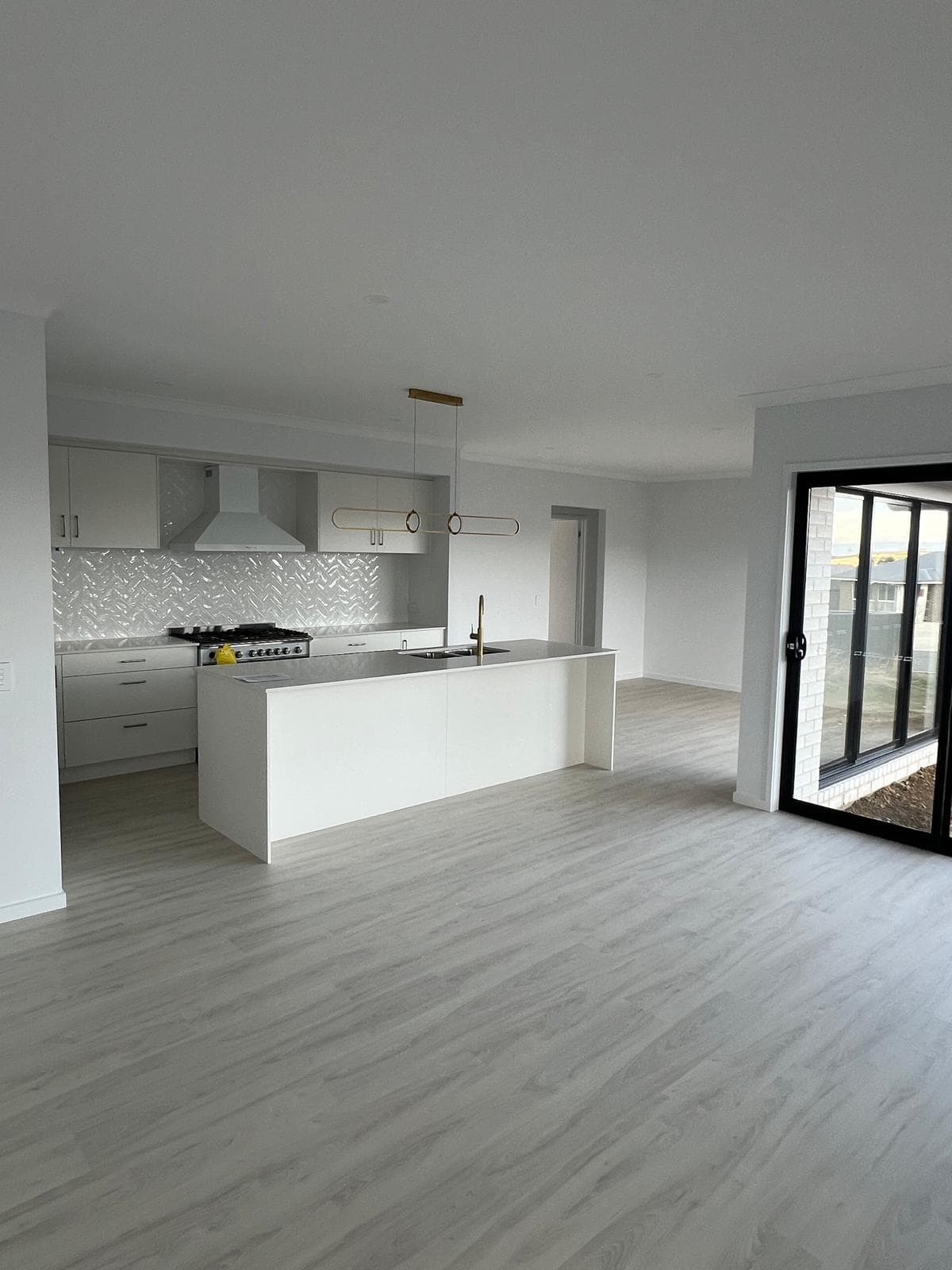 Bright open-plan kitchen and living after a deep clean