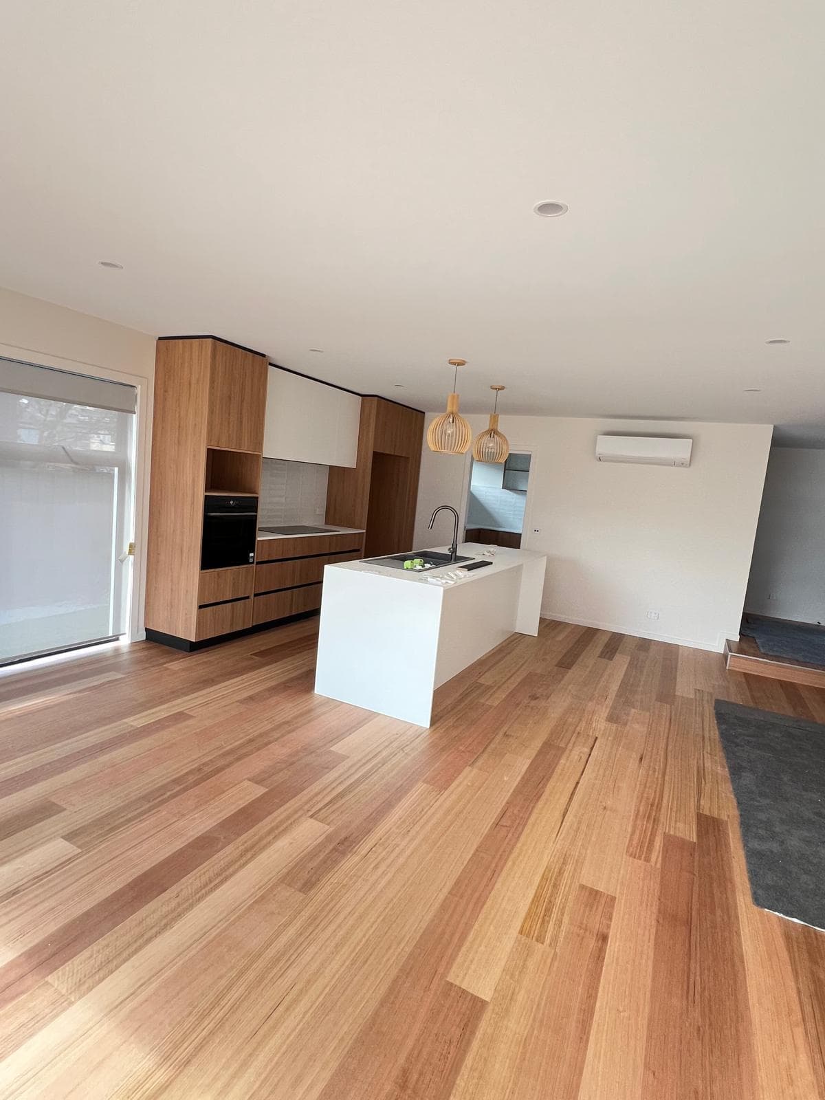Freshly painted open-plan living with crisp white walls and ceiling